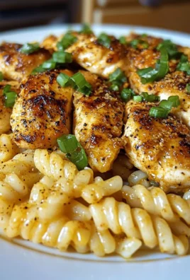 GARLIC BUTTER CHICKEN OVER CHEESY CAJUN ROTINI
